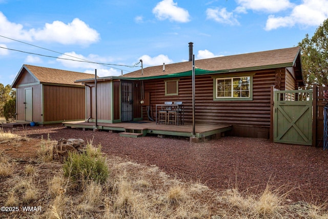1919 Daggs St, Show Low, AZ 85901 - back of property with a wooden deck, a storage shed, and roof with shingles