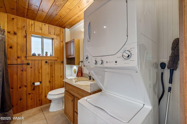 1919 Daggs St, Show Low, AZ 85901 - bathroom featuring stacked washer / dryer, wooden ceiling, wood walls, tile patterned floors, and vanity
