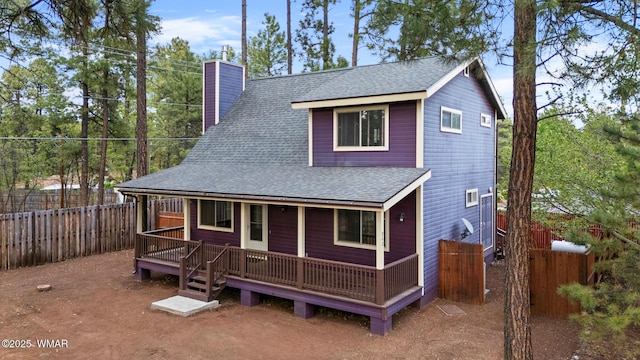 242 E Pinecrest Dr, Pinetop, AZ 85935 - view of front facade featuring roof with shingles, a chimney, and a fenced backyard