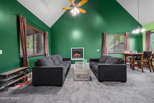 242 E Pinecrest Dr, Pinetop, AZ 85935 - living room featuring carpet flooring, high vaulted ceiling, ceiling fan, a warm lit fireplace, and a chandelier