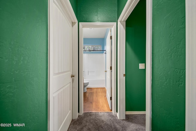 242 E Pinecrest Dr, Pinetop, AZ 85935 - hall featuring a textured wall, dark colored carpet, and baseboards