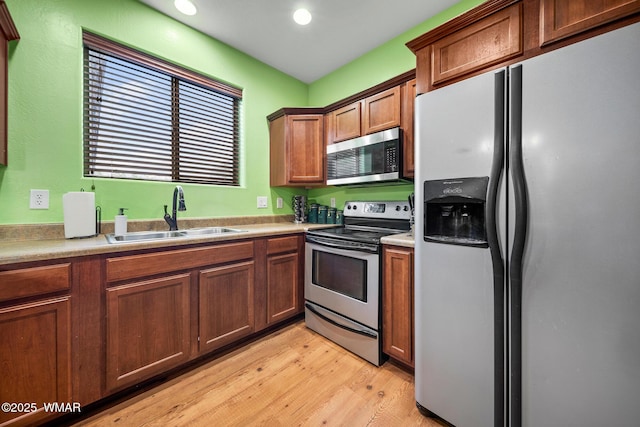 242 E Pinecrest Dr, Pinetop, AZ 85935 - kitchen featuring stainless steel appliances, a sink, light wood-type flooring, brown cabinets, and recessed lighting