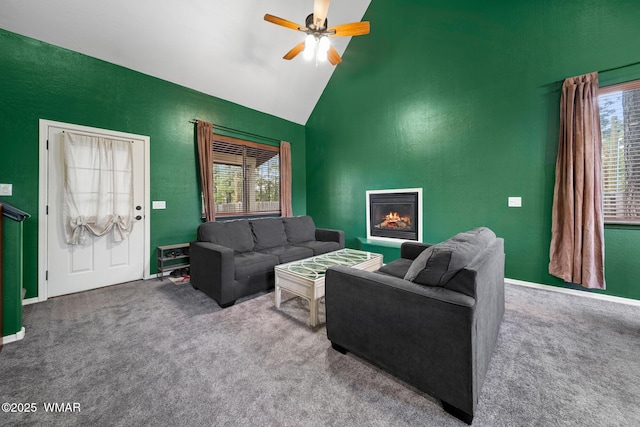 242 E Pinecrest Dr, Pinetop, AZ 85935 - carpeted living room with a ceiling fan, a warm lit fireplace, high vaulted ceiling, and baseboards