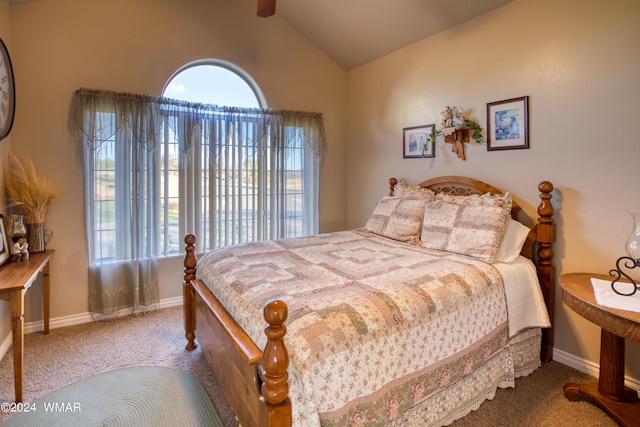 carpeted bedroom featuring lofted ceiling and baseboards