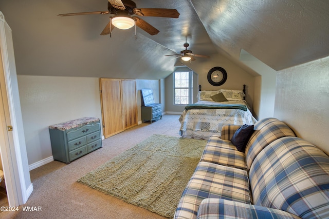 bedroom featuring light carpet, baseboards, ceiling fan, vaulted ceiling, and a textured ceiling