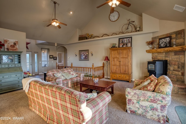 living room with light carpet, visible vents, arched walkways, ceiling fan, and high vaulted ceiling