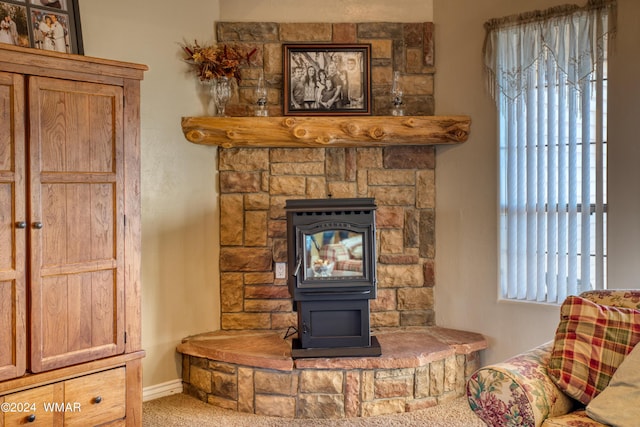 interior details with carpet floors and a wood stove