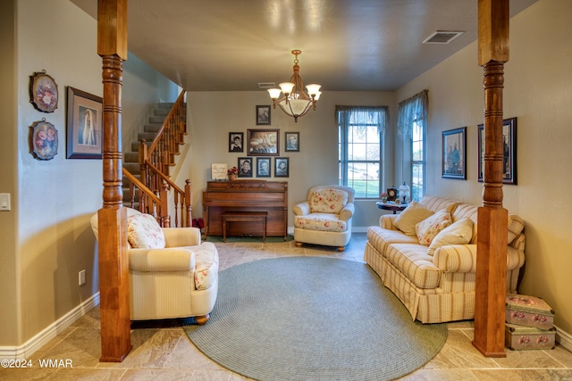 sitting room with a chandelier, visible vents, baseboards, and stairs