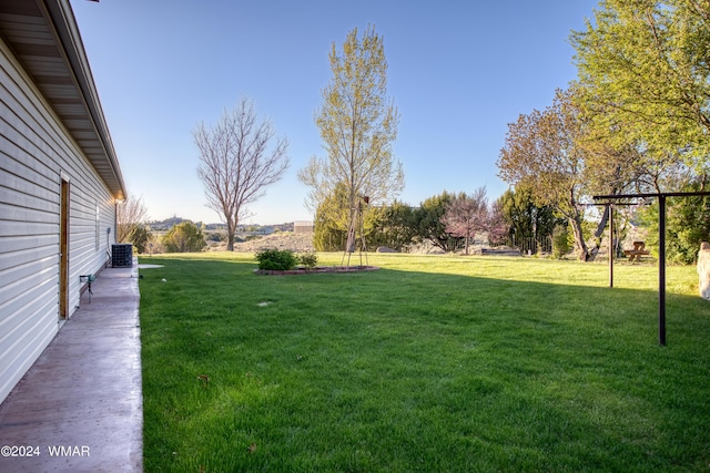 view of yard featuring central air condition unit