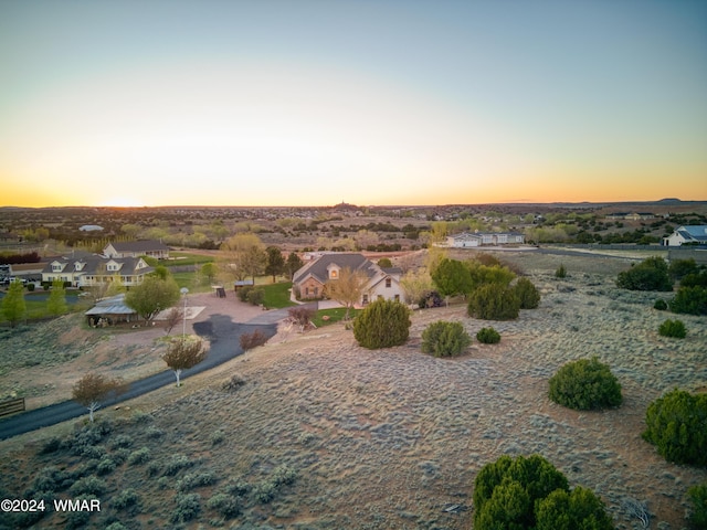 aerial view at dusk featuring a residential view