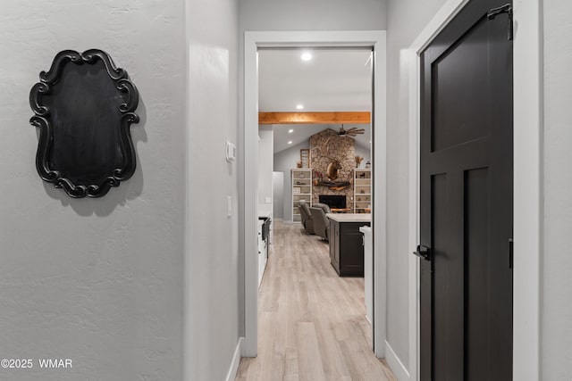 hall with light wood-style floors, recessed lighting, and baseboards