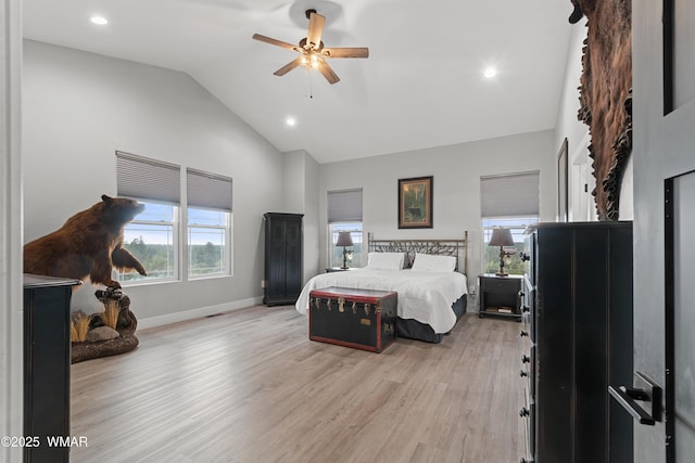 bedroom featuring light wood finished floors, baseboards, recessed lighting, a ceiling fan, and high vaulted ceiling