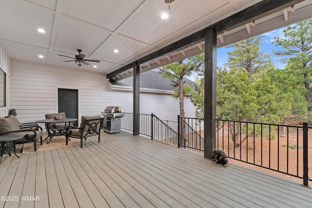 wooden deck featuring a ceiling fan, grilling area, and outdoor dining space