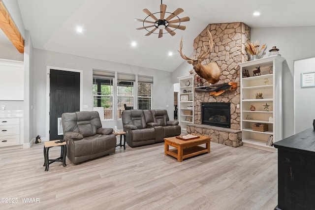 living area with ceiling fan, a fireplace, light wood-type flooring, recessed lighting, and high vaulted ceiling
