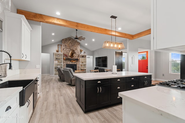 kitchen featuring dark cabinetry, ceiling fan, white cabinetry, light wood-type flooring, and recessed lighting