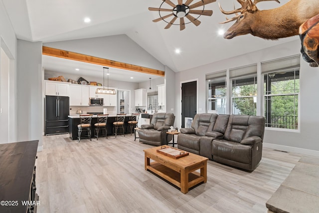 living room featuring ceiling fan, high vaulted ceiling, baseboards, light wood finished floors, and recessed lighting