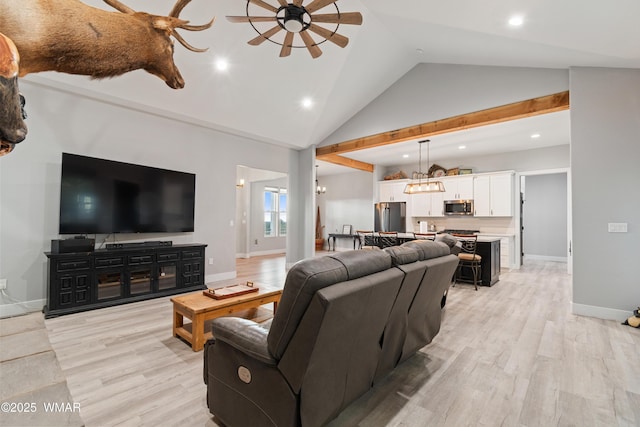 living room with recessed lighting, light wood-style floors, ceiling fan, high vaulted ceiling, and a chandelier