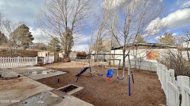 view of yard featuring a playground and fence