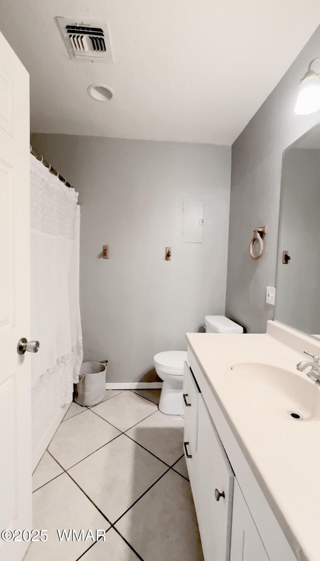 bathroom with toilet, vanity, visible vents, and tile patterned floors