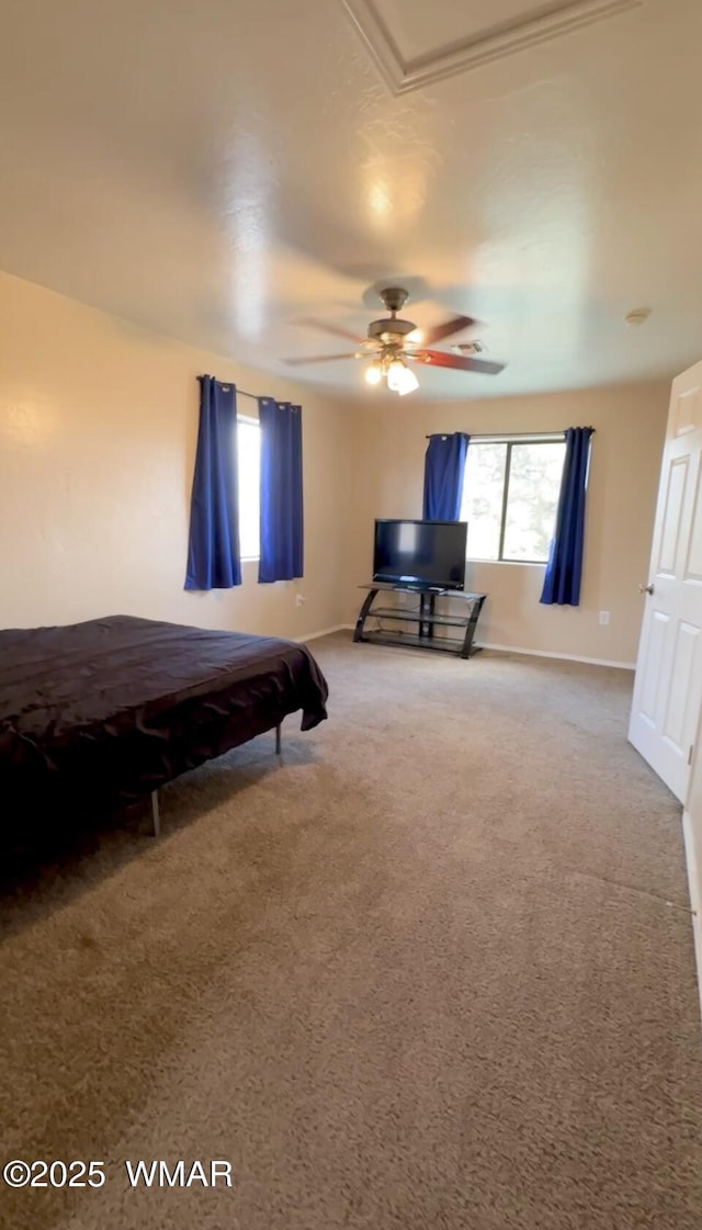 carpeted bedroom with a ceiling fan and baseboards