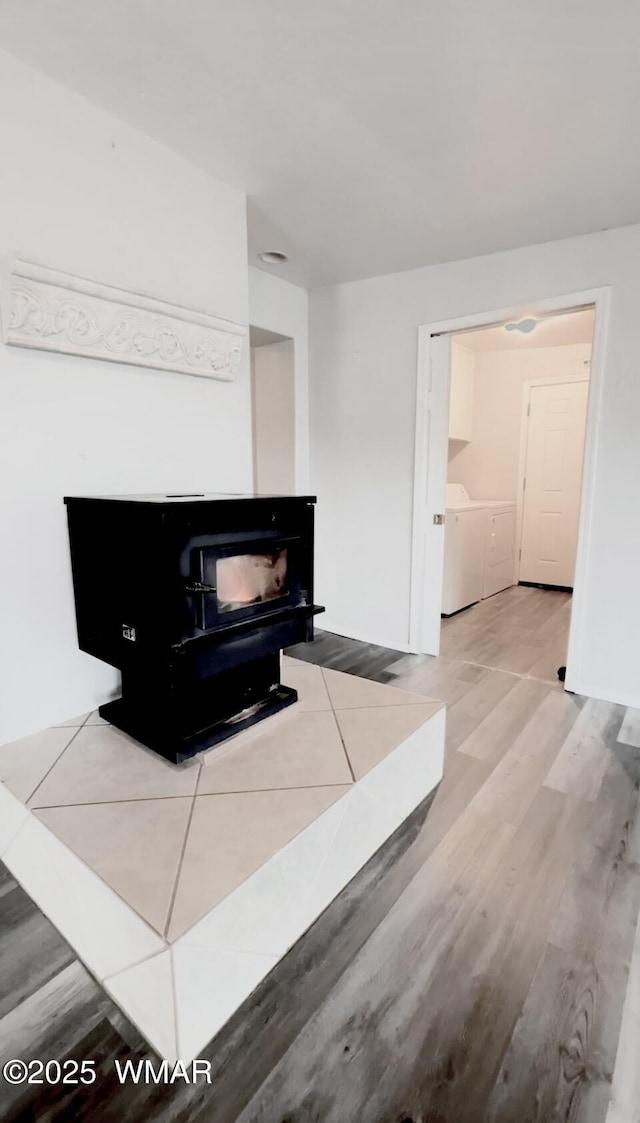 interior space featuring washing machine and clothes dryer and wood finished floors