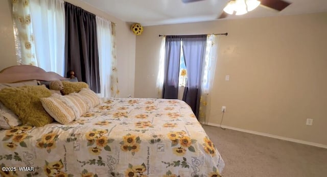 carpeted bedroom featuring a ceiling fan and baseboards