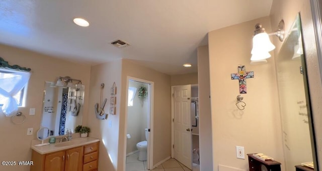 full bathroom with baseboards, visible vents, toilet, tile patterned floors, and vanity