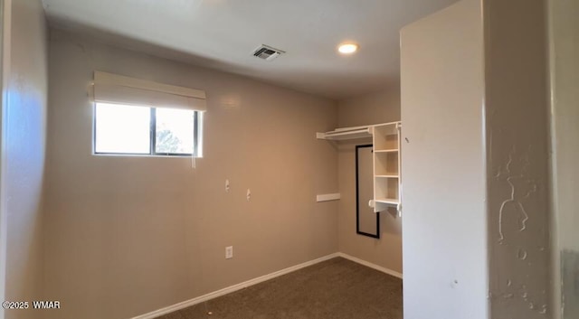 interior space with dark colored carpet and visible vents