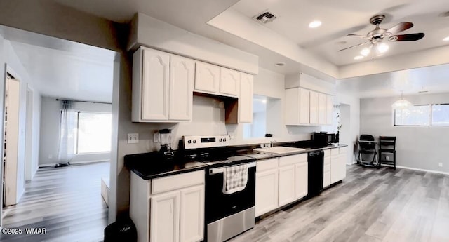 kitchen featuring black dishwasher, dark countertops, visible vents, stainless steel range with electric cooktop, and white cabinets