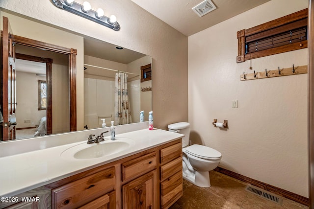 full bath with vanity, visible vents, baseboards, and toilet