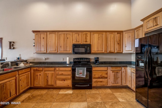 kitchen featuring a sink, brown cabinetry, black appliances, and a high ceiling