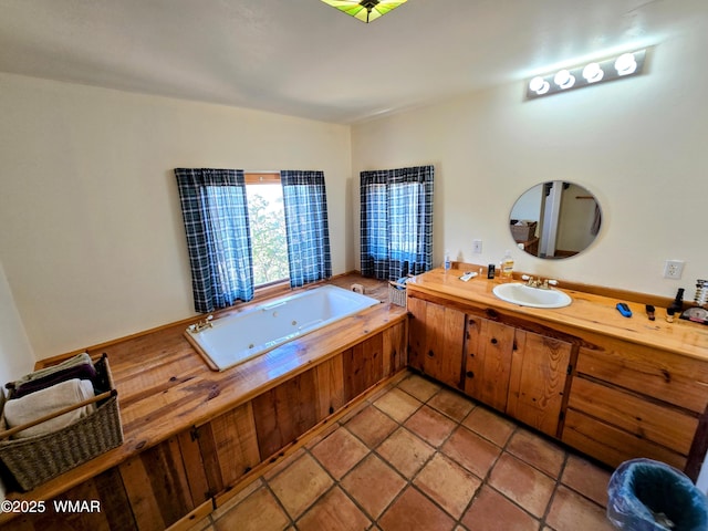 bathroom with a bath, vanity, a tile shower, and tile patterned floors