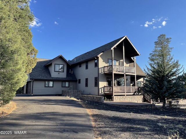 2321 Chandelle Ln, Overgaard, AZ 85933 - view of front facade with a balcony and a shingled roof