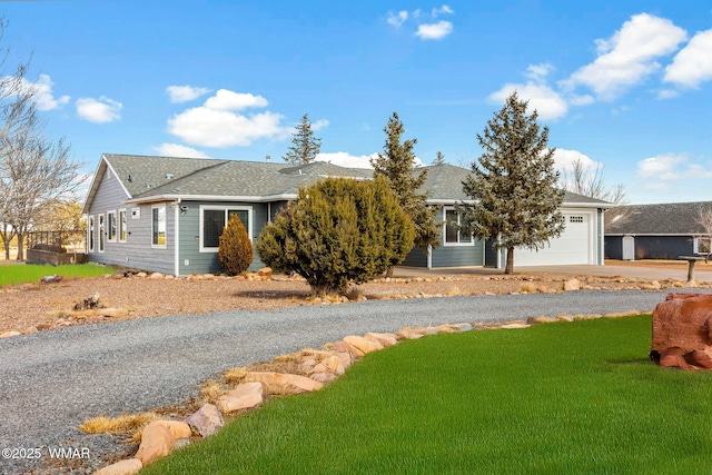 ranch-style home featuring a garage, a front yard, and concrete driveway