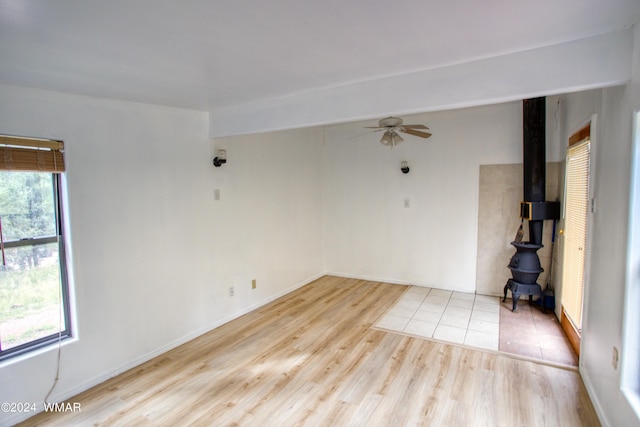 1144 Christopher Creek Loop, Payson, AZ 85541 - spare room featuring a wood stove, wood finished floors, and a ceiling fan