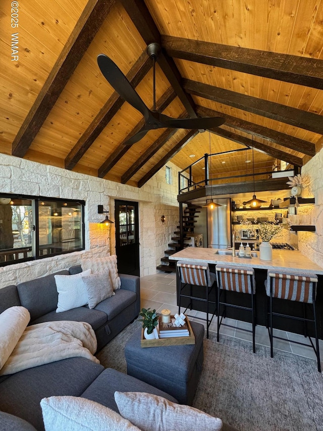 living room with wood ceiling, stairway, high vaulted ceiling, and beamed ceiling