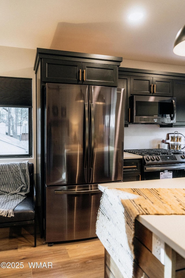 4251 Branding Iron Loop, Pinetop, AZ 85935 - kitchen featuring appliances with stainless steel finishes, light countertops, light wood-style floors, and dark cabinetry