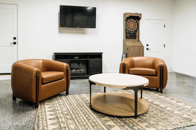 4251 Branding Iron Loop, Pinetop, AZ 85935 - sitting room featuring a glass covered fireplace and speckled floor