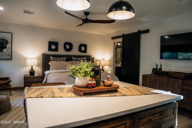4251 Branding Iron Loop, Pinetop, AZ 85935 - bedroom featuring a barn door, wood finished floors, and a ceiling fan