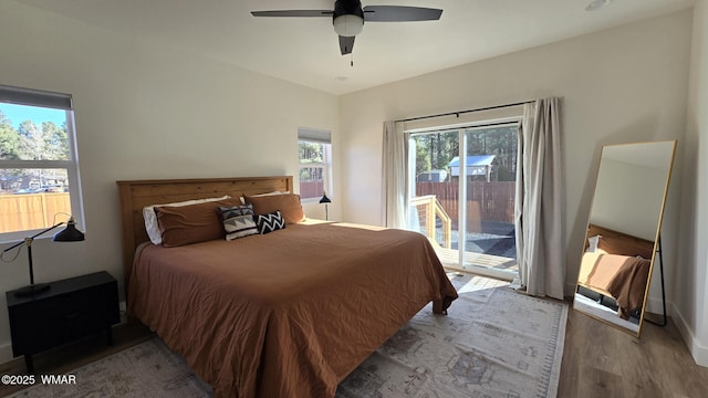 bedroom featuring access to exterior, ceiling fan, and wood finished floors