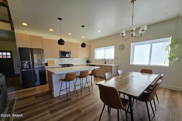 dining space with recessed lighting, baseboards, a notable chandelier, and dark wood-style floors