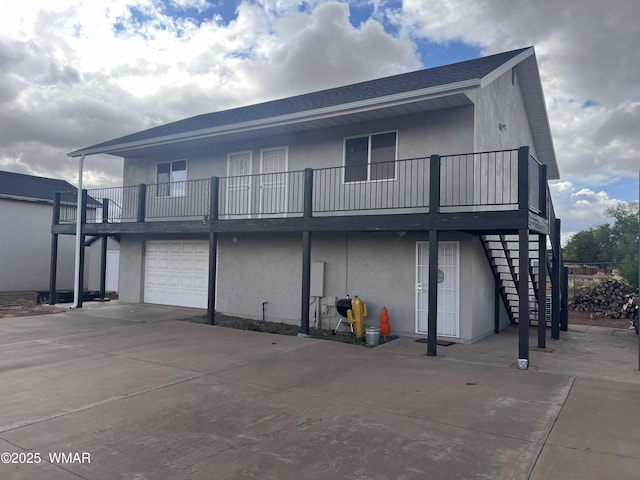 195 S 4th St, Snowflake, AZ 85937 - back of property with stucco siding, driveway, a garage, and stairs