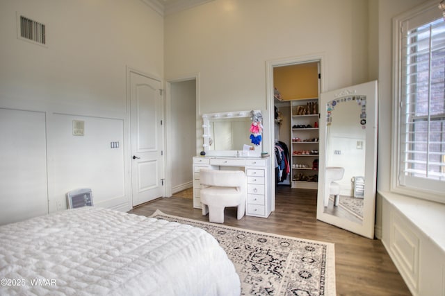 7444 Caldwell Canyon Rd, Snowflake, AZ 85937 - bedroom featuring a spacious closet, wood finished floors, a towering ceiling, a closet, and crown molding