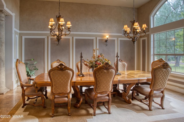 7444 Caldwell Canyon Rd, Snowflake, AZ 85937 - dining space with a chandelier, ornate columns, a decorative wall, and a high ceiling