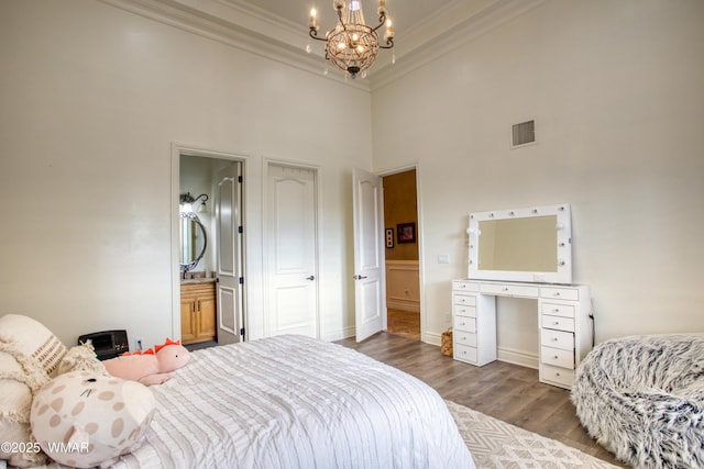 7444 Caldwell Canyon Rd, Snowflake, AZ 85937 - bedroom featuring crown molding, wood finished floors, a chandelier, a high ceiling, and baseboards