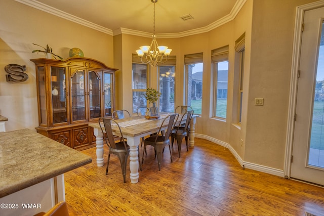 7444 Caldwell Canyon Rd, Snowflake, AZ 85937 - dining area with a chandelier, light wood finished floors, crown molding, and baseboards
