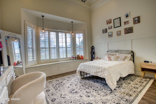 7444 Caldwell Canyon Rd, Snowflake, AZ 85937 - bedroom with ornamental molding, wood finished floors, a chandelier, a wainscoted wall, and a decorative wall