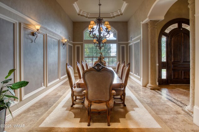 7444 Caldwell Canyon Rd, Snowflake, AZ 85937 - dining area featuring a chandelier, arched walkways, ornate columns, a decorative wall, and a towering ceiling