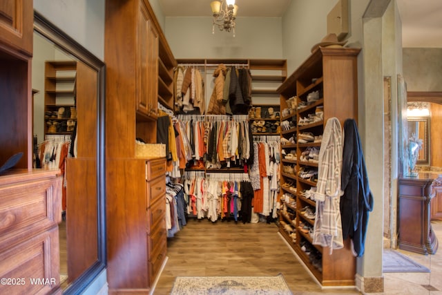 7444 Caldwell Canyon Rd, Snowflake, AZ 85937 - walk in closet featuring light wood finished floors and a chandelier