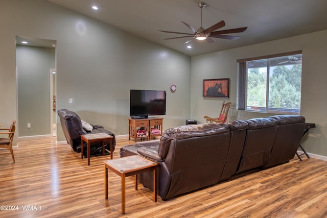 living area with vaulted ceiling, recessed lighting, a ceiling fan, and light wood-style floors